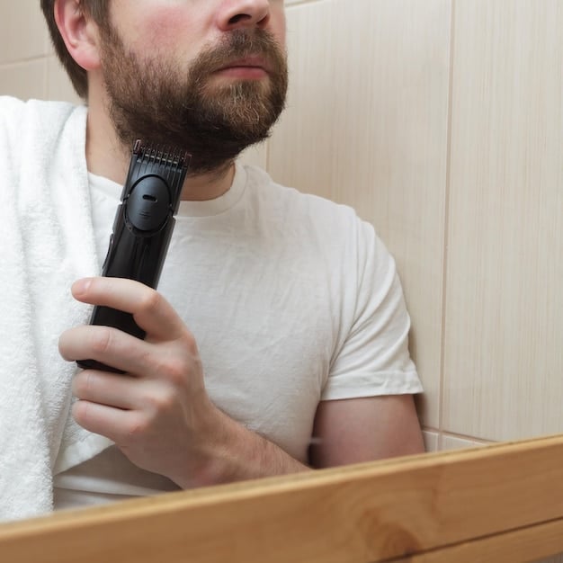 A man is meticulously grooming his beard in a well-lit bathroom. He is using a small comb to shape his beard, and there are various beard care products on the counter, including beard oil and balm. The scene conveys attention to detail and a commitment to personal grooming.
