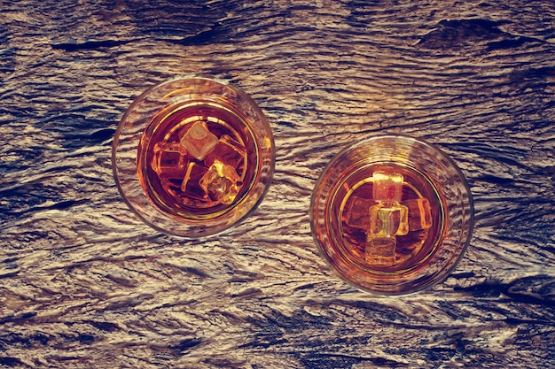 A close-up shot of different types of whiskey (bourbon, scotch, rye) in various glasses, showcasing the different colors and textures of each type.
