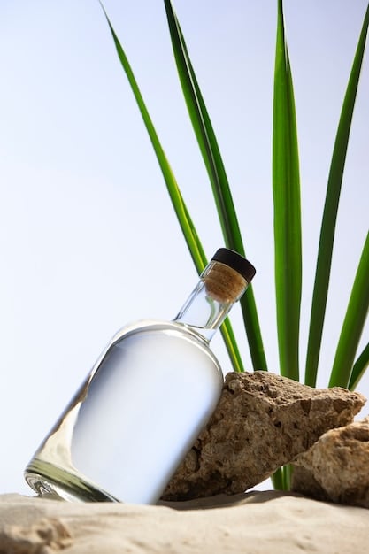 An artistic shot of a bottle of tequila being poured into a shot glass, with agave plants in the background, emphasizing the origin and natural ingredients of the spirit.