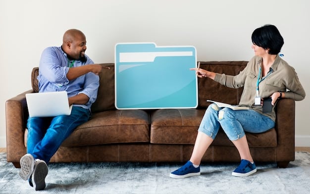 A couple sitting on a couch, having a serious but calm discussion while looking at a laptop displaying charts and graphs.