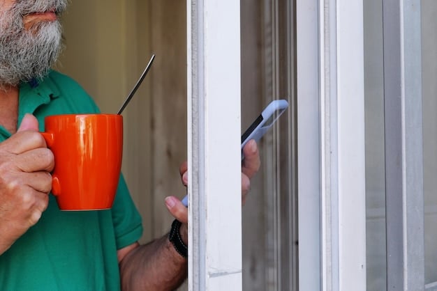 A person is inspecting the caulking around a window frame, pointing out a visible crack with a screwdriver. The setting is a well-lit living room during daytime.