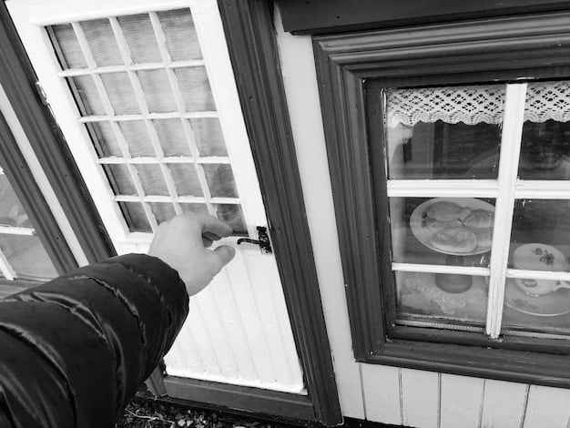 Hands applying caulk to the exterior of a window frame, with a caulk gun clearly visible. The background includes a suburban home during a sunny winter day.
