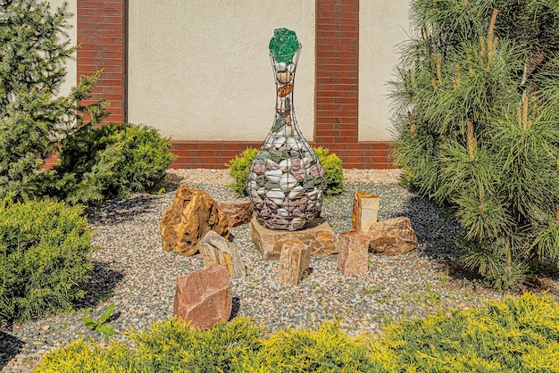 A small, budget-friendly patio design featuring gravel, stepping stones, and potted plants, with a simple seating arrangement.