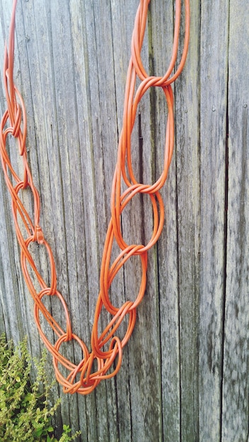 Close-up of a very old, frayed electrical wire with exposed copper conductors.