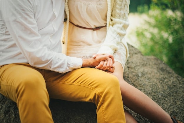 A couple sitting back-to-back, but their hands are intertwined, symbolizing connection despite emotional distance, in a soft, muted setting.