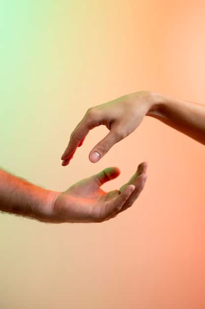 Two hands gently touching, one palm facing up and the other reaching down, symbolizing support, understanding, and the delicate balance of connection and personal space.