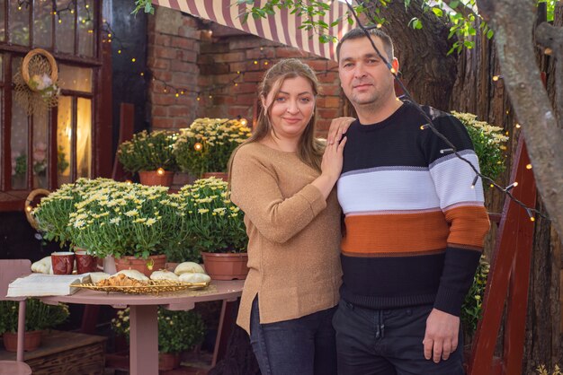 A couple, mid-30s, looking confidently at a bright future. They are standing arm-in-arm, smiling broadly, with a subtle cityscape or sunrise in the background, symbolizing financial growth and collective achievement. Their attire is business casual, suggesting a professional yet approachable demeanor.