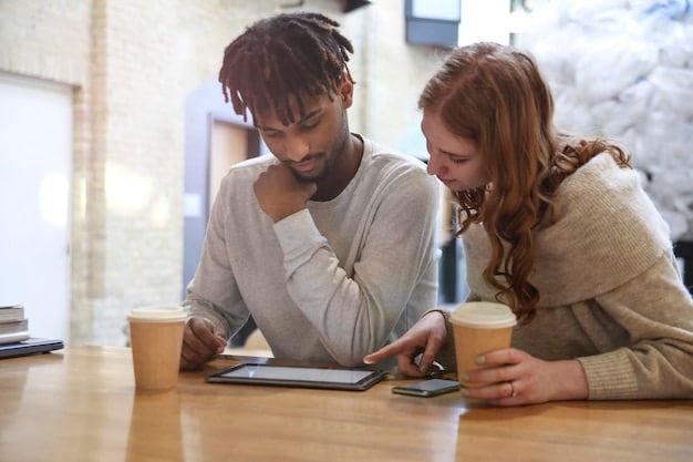 Two people discussing investment charts on a tablet, with a calculator and coffee on a table, representing thoughtful investment planning for couples.