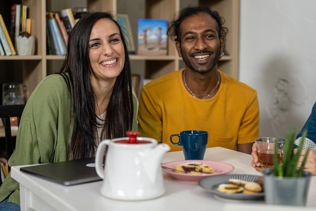 A diverse couple in their late 20s, early 30s, sitting at a kitchen table, looking at a spreadsheet on a laptop, with focused expressions, a coffee cup and some financial documents nearby, illustrating ongoing financial review and planning.