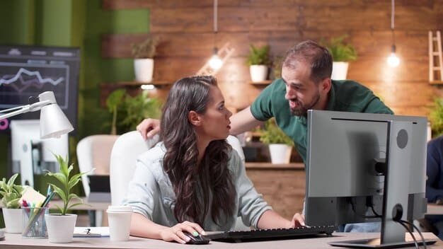 A couple enthusiastically pointing at a financial chart on a computer, looking excited and collaborative. The room is brightly lit, reflecting a sense of optimism and clear direction.