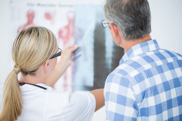 A pain specialist consulting with a senior patient, pointing to a diagram of the spine, representing advanced pain management techniques.