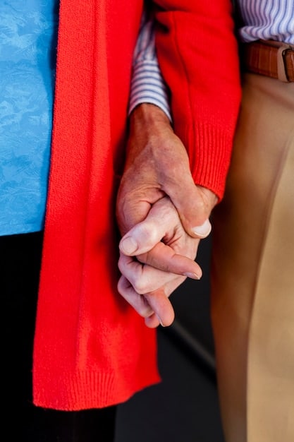 A close-up of two elderly hands gently holding, symbolizing comfort, support, and the deep emotional benefits of human touch and connection.