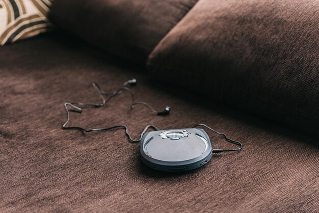 A close-up shot of a modern, sleek behind-the-ear (BTE) hearing aid resting on a clean surface, highlighting its compact design and advanced features. The lighting is bright and clear, showing intricate details.