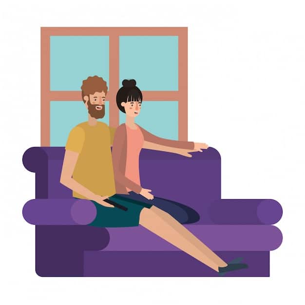 A couple sitting on a sofa, engaged in conversation. One partner is clearly leaning in, making eye contact, and nodding, showing they are actively listening to the other. The setting is cozy and intimate.