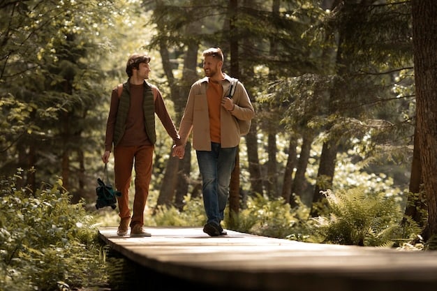 A couple holding hands and walking on a hiking trail surrounded by lush greenery, with sunlight filtering through the trees, emphasizing a serene and active date idea.