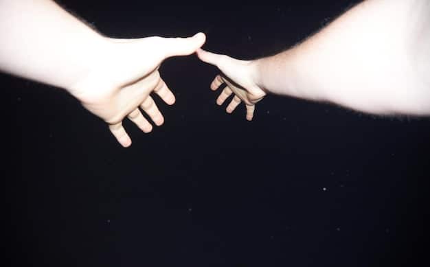 Two hands reaching out, almost touching, symbolizing connection and understanding overcoming distance or misunderstanding.
