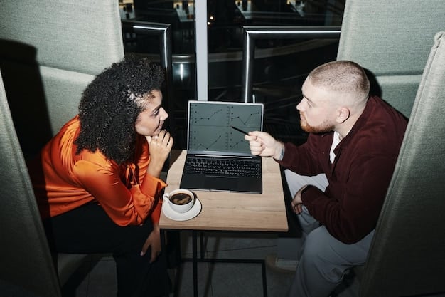 A couple sits with a financial advisor, one partner points to a screen with charts while the other nods thoughtfully, signifying professional guidance in overcoming financial communication barriers.